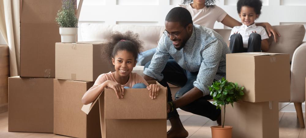 Family opening moving boxes that may contain household pests